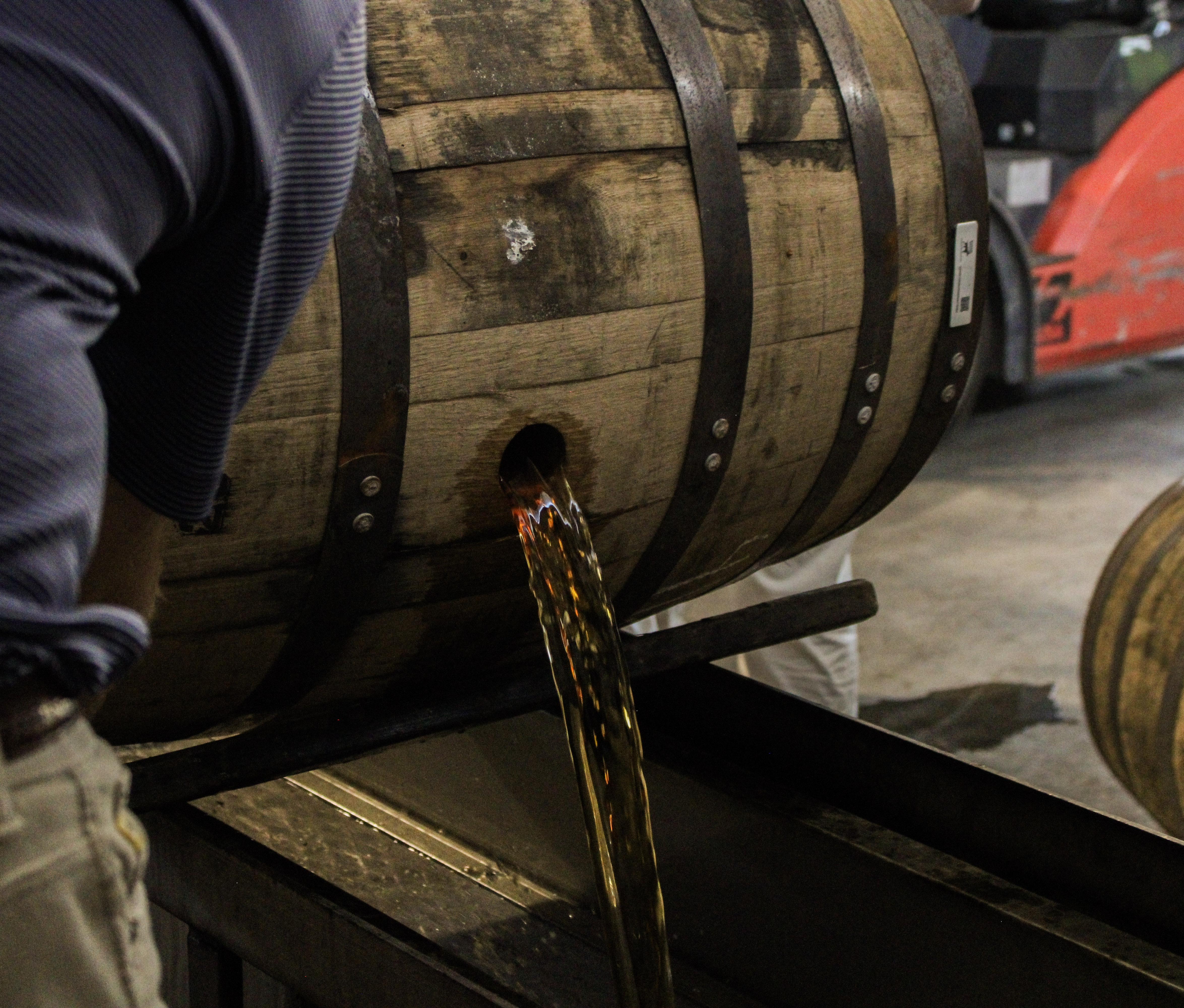 Bourbon pouring from the barrel, the raw craft